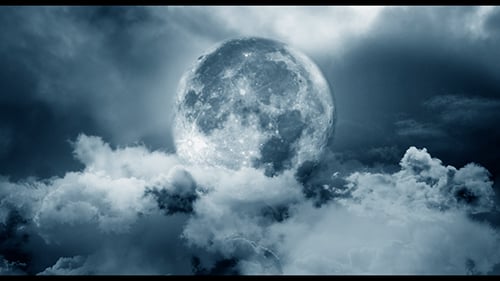 Dramatic Full Moon Over Moving Clouds