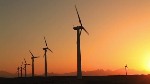 Wind Turbines at Sunset Sky Background