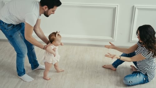 Dad Teaches His Little Daughter To Walk. Baby's First Steps