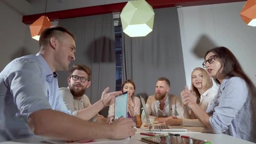 Team Discussing Business Around Table at Workplace