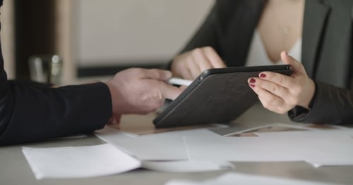 Coworkers Reviewing Tablet Together at Work