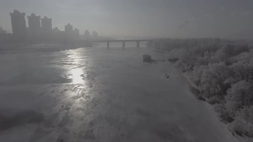 Flying Over the Frozen River, the Distance Can Be Seen the City