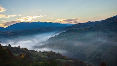 Scenic Sunrise Over Rolling Foggy Mountain Hills