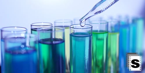 Colorful Liquids Being Added to Test Tubes