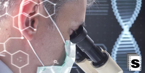 Looking into Microscope in the Lab