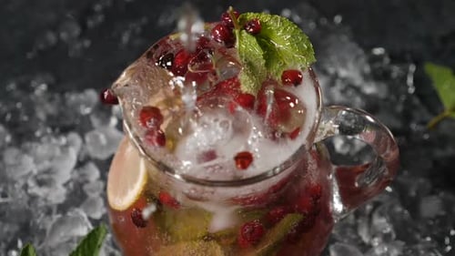 Pouring Sparkling Beverage in a Cranberry Pitcher