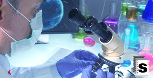 Scientists Working in Laboratory with Microscope
