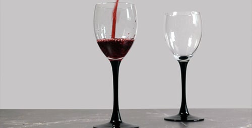 Pouring Red Wine into a Wine Glass