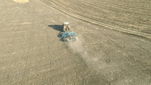 Tractor Plowing Field Aerial View
