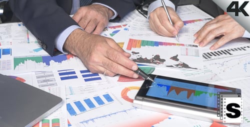 Businessmen Analyzing Data with Technology in Office