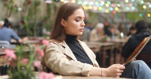 Woman Looking Through Menu