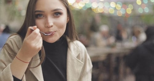 Woman Enjoying Food at Urban Cafe