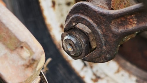 Mechanic Tightening the Screws. Rusted Parts