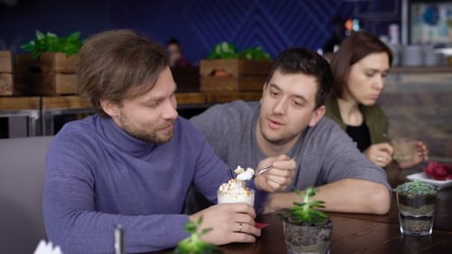Man Eating Dessert with Friends