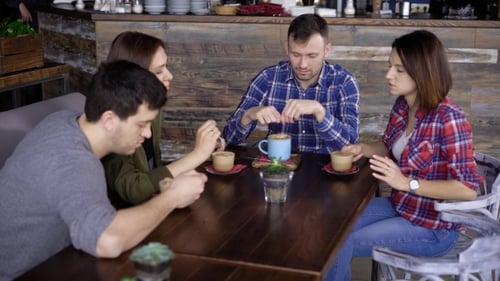 Friends Enjoying Coffee and Conversation in a Cafe