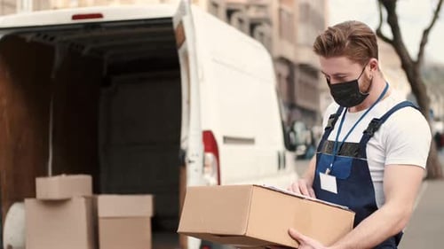 Delivery Driver Checking His List of Parcels