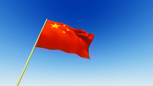 Chinese Flag Waving In Wind Against Blue Sky Loop