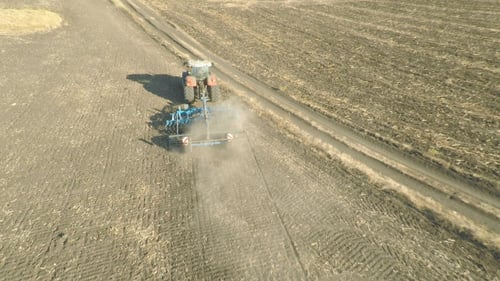 Tractor Tilling Field in Rural Countryside