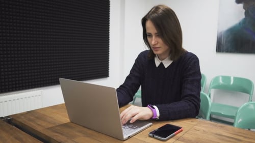 Woman Works at Laptop in Modern Office