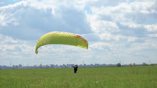 Male Paraglider, Checks Equipment on the Ground. Safety Is Important for Flying in the Sky.