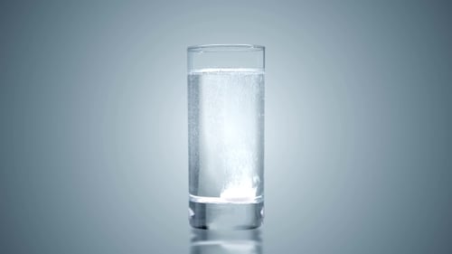 Effervescent Tablet Dissolving in a Glass of Water