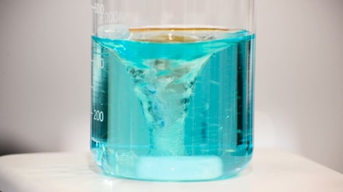Beaker with Turquoise Solution Mixing with Stirrer
