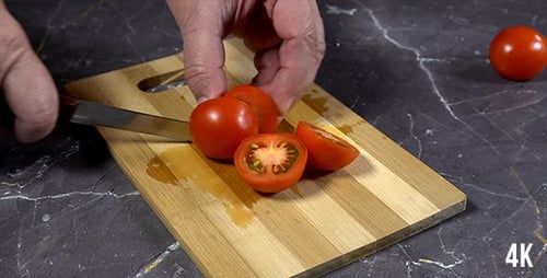 Slicing Fresh Red Tomatoes on Wooden Board