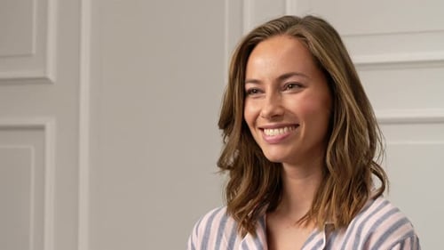 Woman Smiling and Playing with her Hair