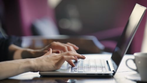 Crop Shot of Female Using Laptop. Crop Shot of Female Sitting in Cafe and Typing at Laptop.