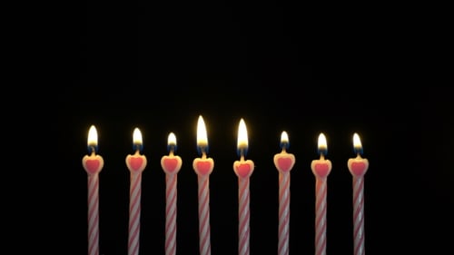 Footage Colorful Burning Candles Set on Black Background.
