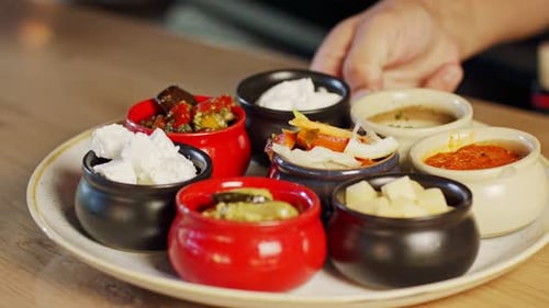 A plate of salads and cheeses served in a restaurant
