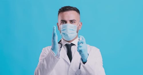 Doctor Shows Hand Sanitizing Technique with Gloves and Mask