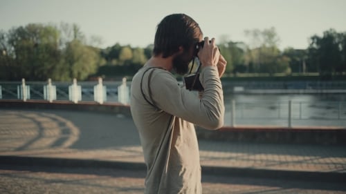 Bearded Man Taking Pictures in an Urban Setting