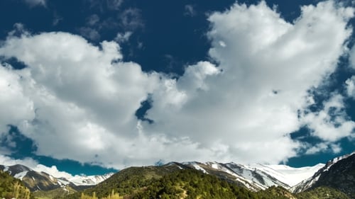 Clouds Drifting Along Top of Rocky Mountain Peaks