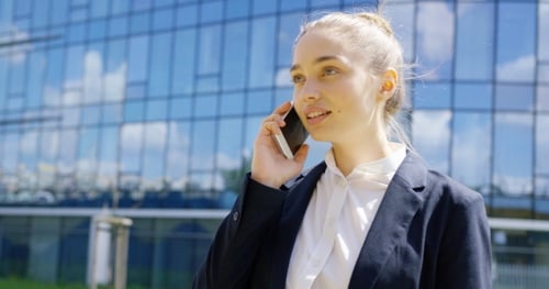 Woman Talking on Cell Phone Outside Office Building