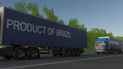 Moving Freight Semi Trucks with PRODUCT OF BRAZIL Caption on the Trailer