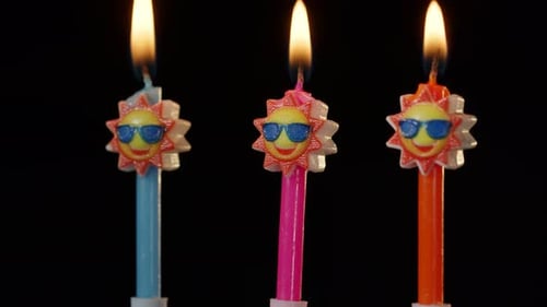 Burning Birthday Candles with Cartoon Suns Wearing Sunglasses
