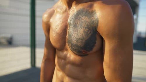 Muscular Shirtless Man Sweating After Intense Workout