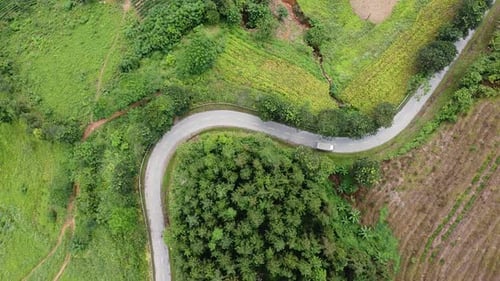 Aerial View of The Road Among The Mountains Around Forests and Jungles Motorcyclists and Cars