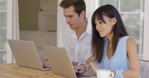 Couple Working at Home on Laptops