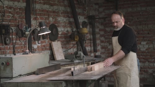 Carpenter Shaping Wood in His Workshop