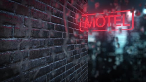 Neon Sign of the Motel Behind the Wet Glass with Drops