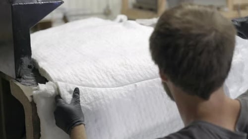 Worker covering oven with soft polystyrene