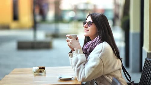 Relaxed Stylish Young Woman Enjoying Break Drinking Hot Coffee Sitting in Cafe on Street Side View