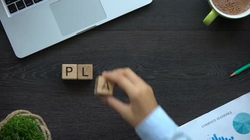 Planning Spelled Out in Wooden Blocks on Desk