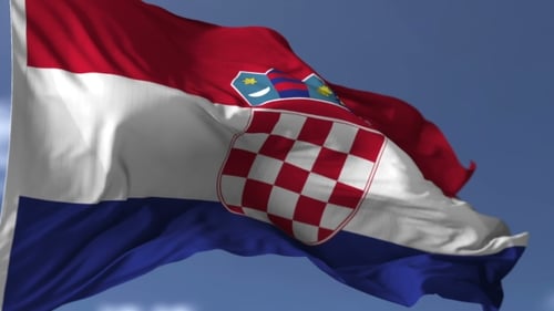 Realistic Waving Flag of Croatia Against Blue Sky