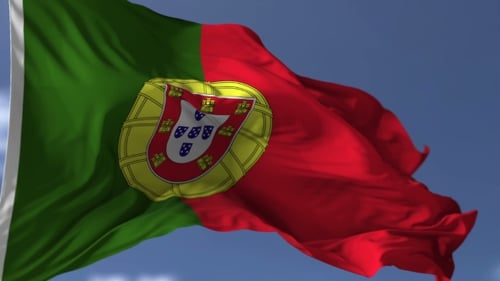 Waving Portugal Flag Against Clear Blue Sky