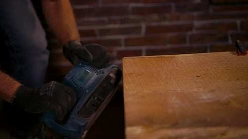 Close Up Shot of a Man's Hands, Who Works with Carpentry Tools in Protective Gloves