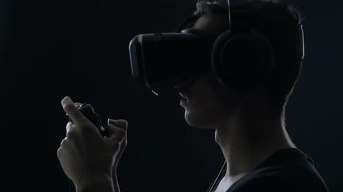 Young Adult Using VR Headset and Controller