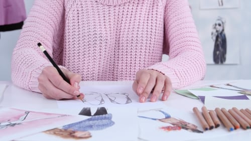 Designer Dress Hands Create Beautiful Drawings with Pencils for the Clothing Magazine.